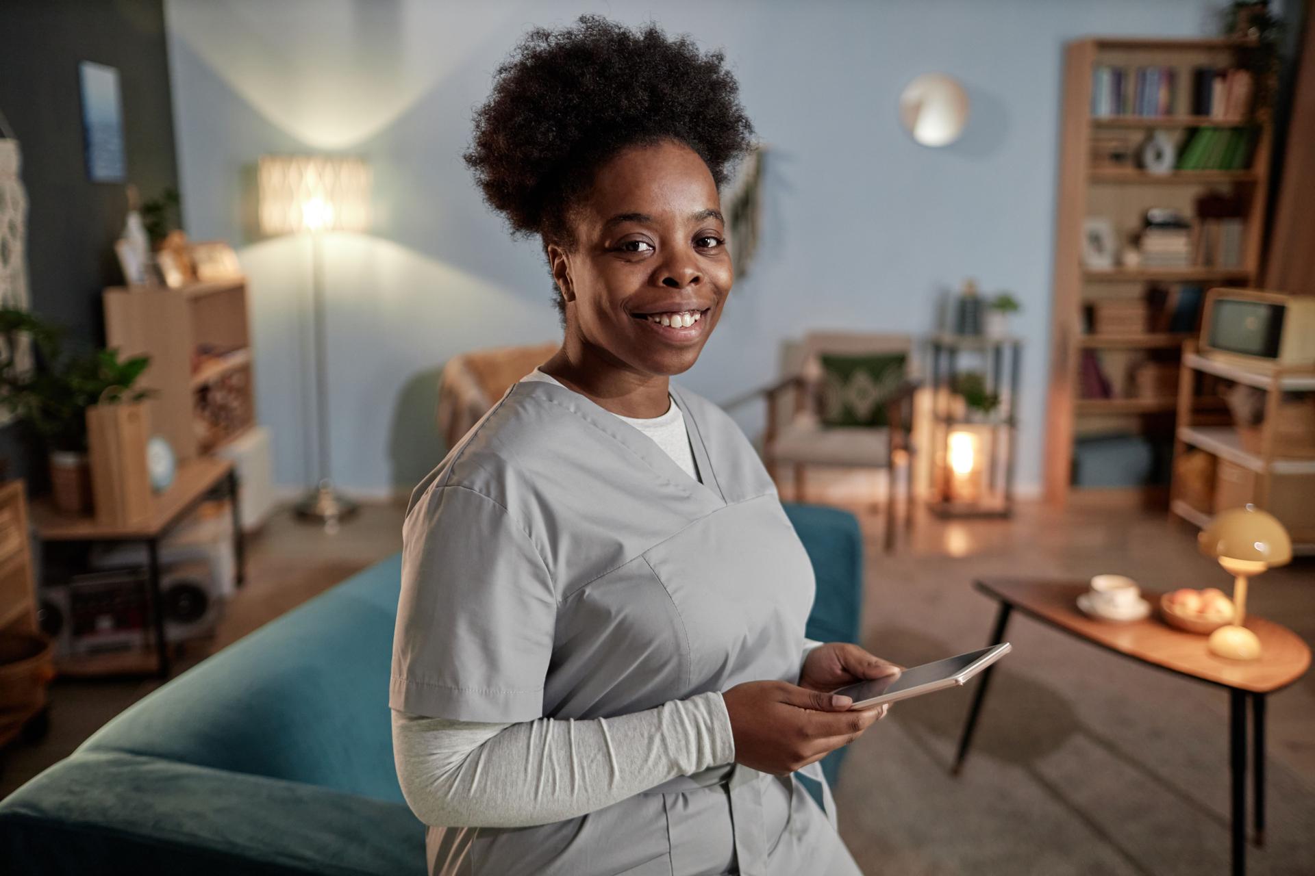 Portrait of Smiling Black Female Caregiver with Digital Tablet during Home Visit